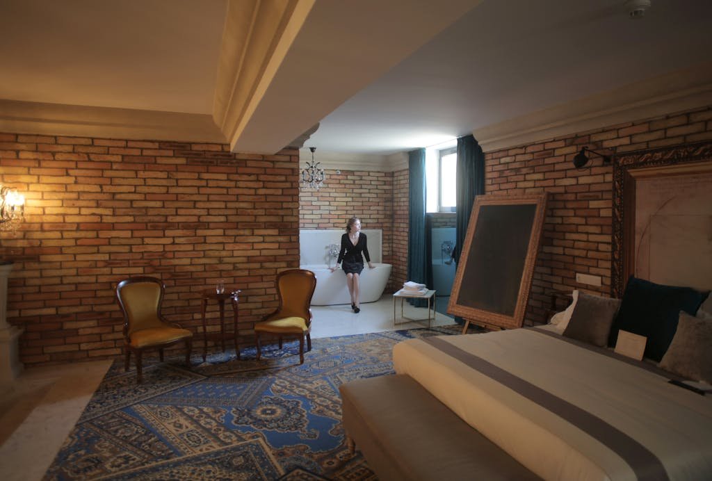 Luxurious hotel room with elegant design and bathtub, creating a relaxing atmosphere.