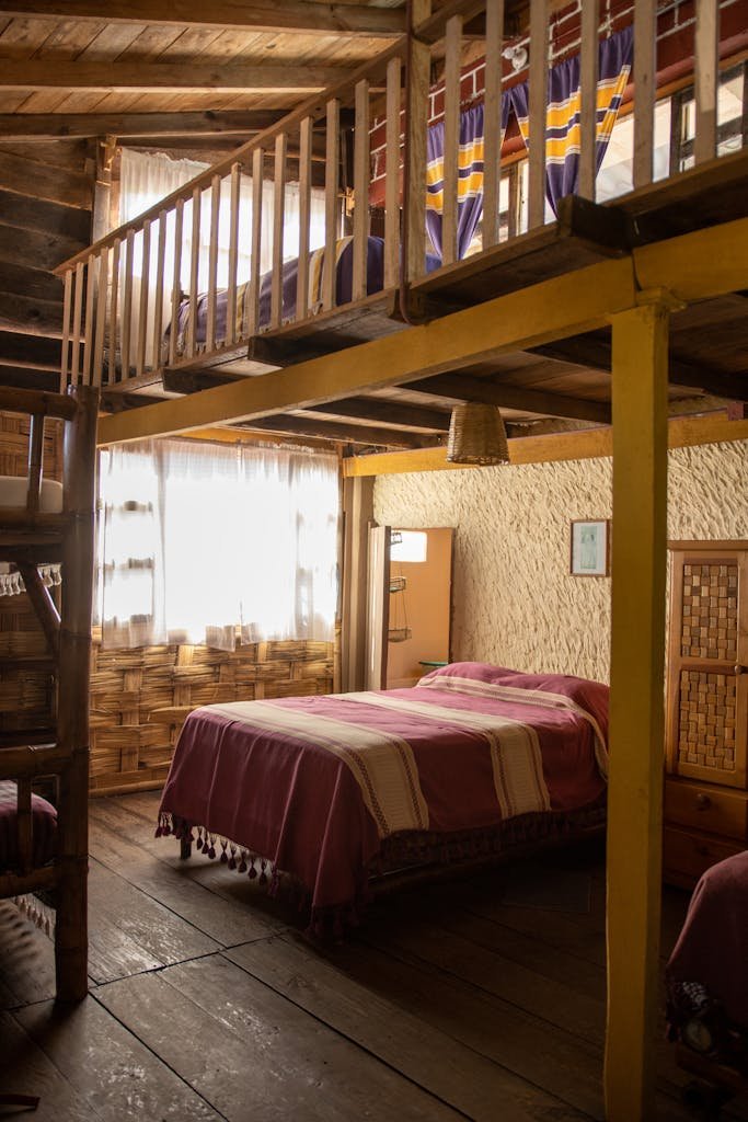 Warm and inviting wooden loft bedroom with cozy decor and natural lighting.